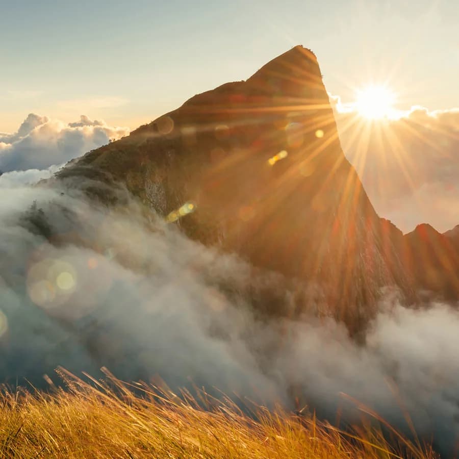 Sunrise breaking over a mountain peak